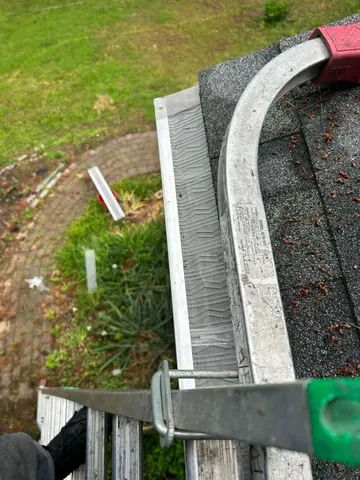 Guard fitted around a curved gutter