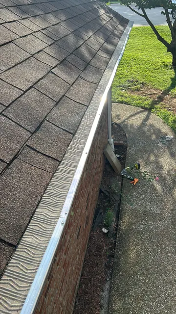 Guard along a shingle roof edge