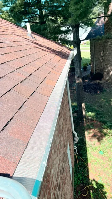 Guard beside a red metal roof